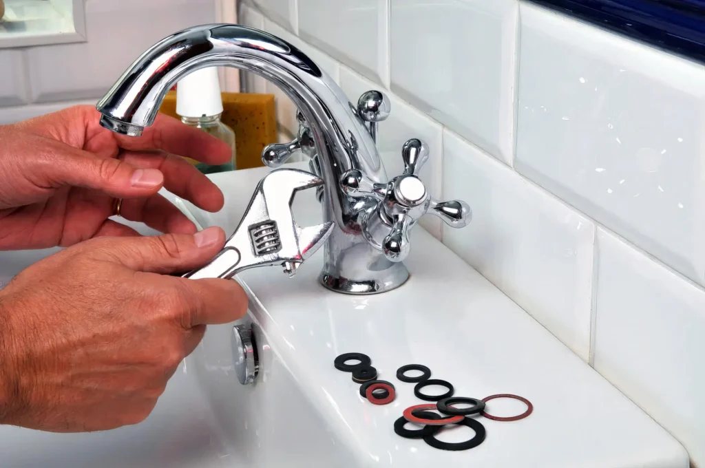 Plumber performing maintenance on a bathroom faucet in Pembroke Pines