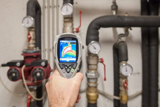 Plumber using a thermal imaging camera to inspect pipes in Pembroke Pines