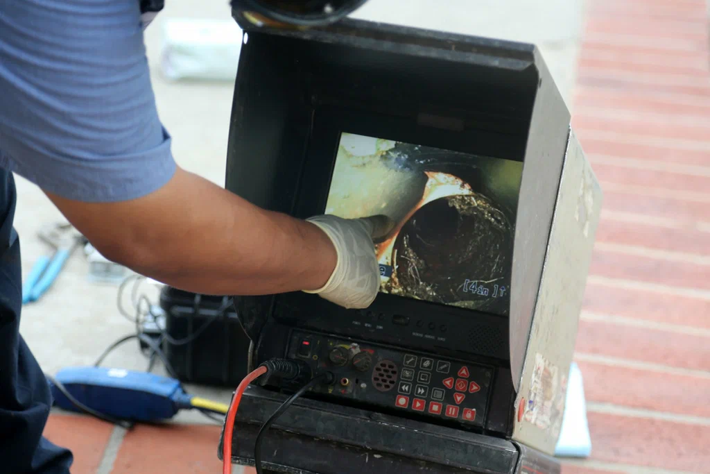 Technician viewing a drain inspection camera in Pembroke Pines