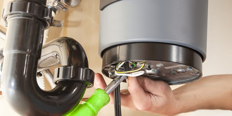 Technician repairing the heating element of a water heater in Pembroke Pines