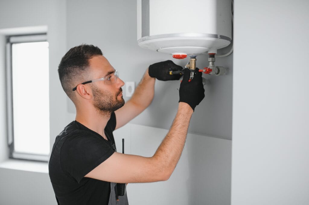 Technician performing water heater maintenance in Pembroke Pines