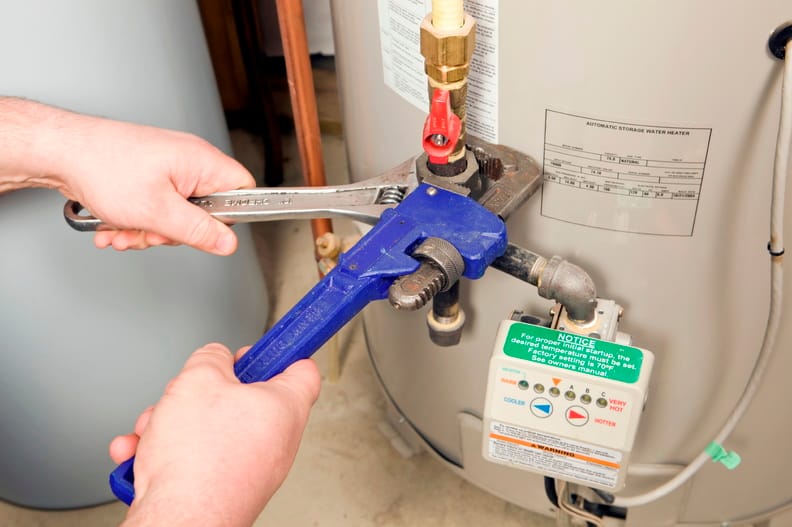 Plumber repairing a water heater valve in Pembroke Pines
